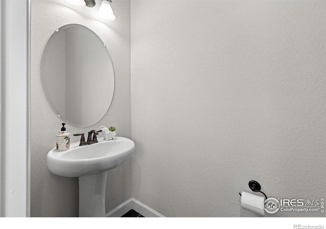 1365 15th Ave, Longmont, CO 80501 - bathroom featuring a sink and baseboards