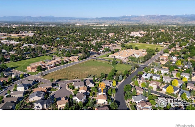 1365 15th Ave, Longmont, CO 80501 - aerial overview of property's location featuring a mountain backdrop and nearby suburban area