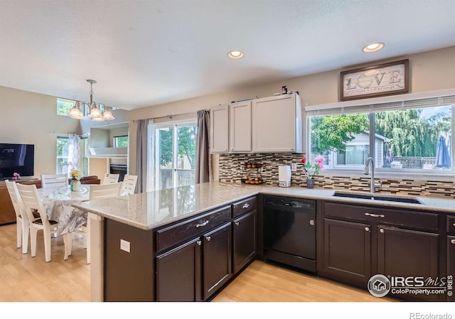 1747 Daisy Ct, Brighton, CO 80601 - kitchen with dishwasher, light wood-type flooring, a peninsula, a chandelier, and recessed lighting