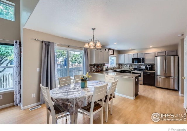 1747 Daisy Ct, Brighton, CO 80601 - dining room with light wood-style floors, a chandelier, and recessed lighting