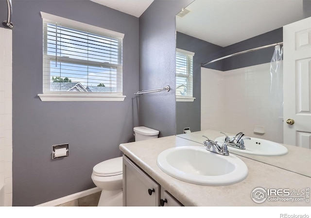 1747 Daisy Ct, Brighton, CO 80601 - bathroom featuring vanity, plenty of natural light, tile patterned flooring, and shower / bath combo