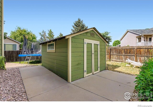 1747 Daisy Ct, Brighton, CO 80601 - view of shed featuring a trampoline and a fenced backyard