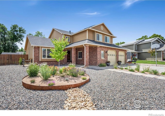 904 Pine Dr, Windsor, CO 80550 - view of front of house featuring brick siding, an attached garage, a shingled roof, and driveway