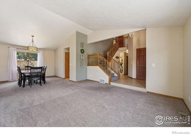 904 Pine Dr, Windsor, CO 80550 - unfurnished dining area featuring lofted ceiling, stairway, carpet floors, and a textured ceiling