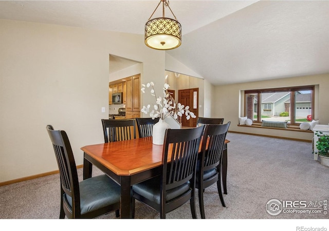 904 Pine Dr, Windsor, CO 80550 - dining space featuring light colored carpet and vaulted ceiling
