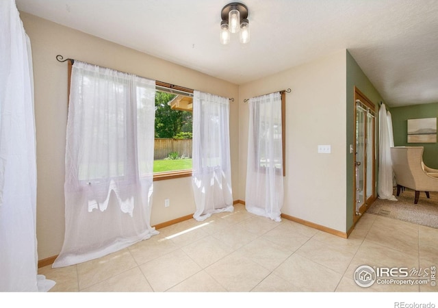 904 Pine Dr, Windsor, CO 80550 - spare room with baseboards and light tile patterned floors
