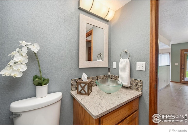904 Pine Dr, Windsor, CO 80550 - half bath featuring vanity, tile patterned floors, and a textured wall