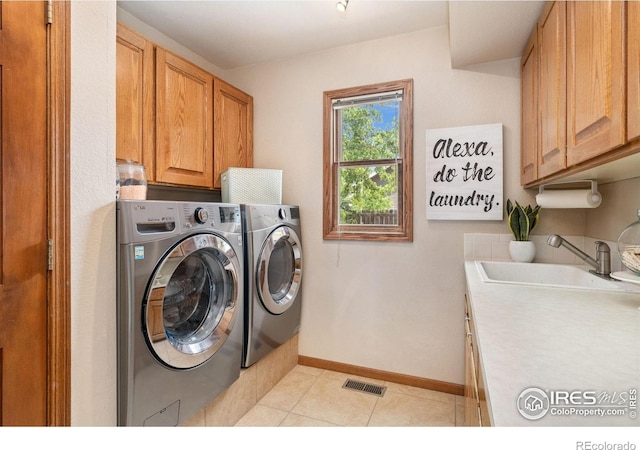 904 Pine Dr, Windsor, CO 80550 - washroom with cabinet space, separate washer and dryer, and light tile patterned floors
