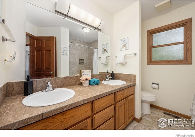 904 Pine Dr, Windsor, CO 80550 - bathroom with double vanity, tile patterned floors, and tiled shower