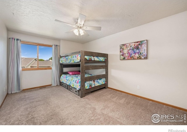 904 Pine Dr, Windsor, CO 80550 - bedroom with carpet, a textured ceiling, and ceiling fan