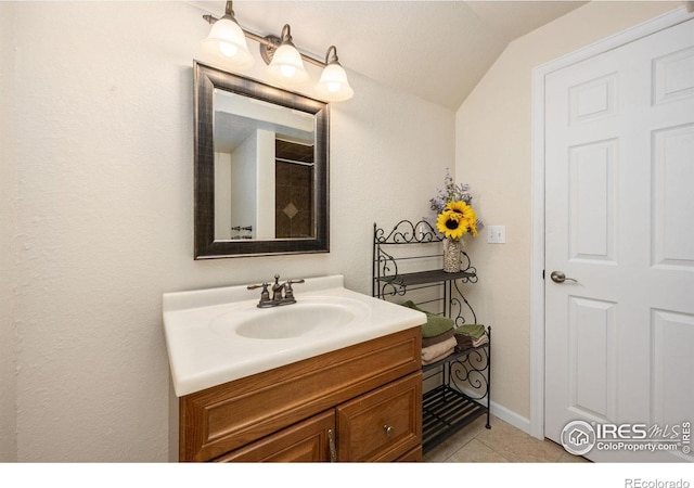 904 Pine Dr, Windsor, CO 80550 - full bathroom featuring vanity, lofted ceiling, and tile patterned flooring