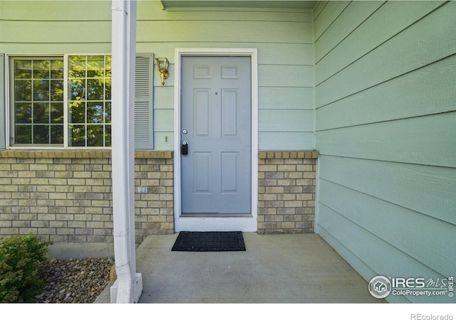 1506 Crestwood Cir, Longmont, CO 80504 - view of exterior entry featuring a porch