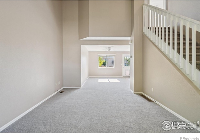 1506 Crestwood Cir, Longmont, CO 80504 - unfurnished living room featuring carpet flooring, a ceiling fan, and a high ceiling