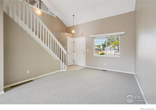 1506 Crestwood Cir, Longmont, CO 80504 - entrance foyer featuring stairs, carpet floors, and high vaulted ceiling