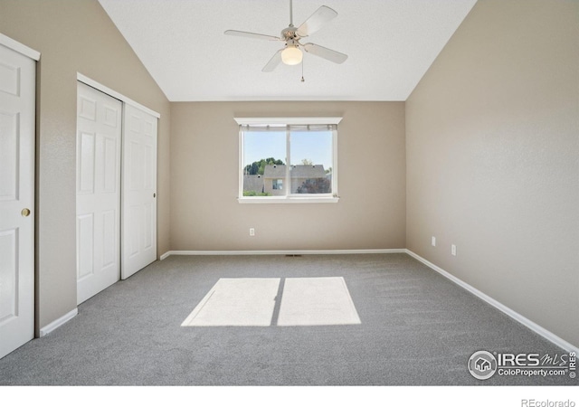 1506 Crestwood Cir, Longmont, CO 80504 - unfurnished bedroom featuring carpet floors, vaulted ceiling, and ceiling fan