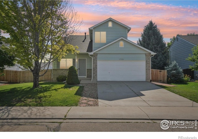 1506 Crestwood Cir, Longmont, CO 80504 - traditional home featuring concrete driveway, brick siding, and an attached garage