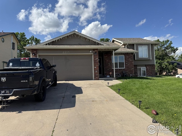 3315 W 35th St, Greeley, CO 80634 - view of front facade featuring brick siding, driveway, a front lawn, and an attached garage