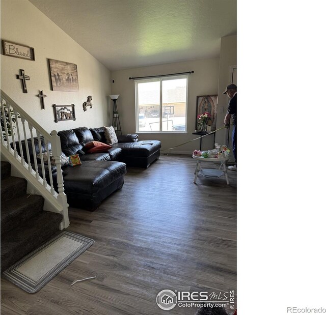 3315 W 35th St, Greeley, CO 80634 - living area with vaulted ceiling, wood finished floors, and stairway