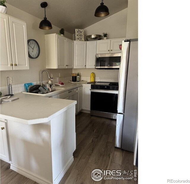 3315 W 35th St, Greeley, CO 80634 - kitchen featuring stainless steel microwave, range with electric stovetop, freestanding refrigerator, dark wood finished floors, and white cabinetry