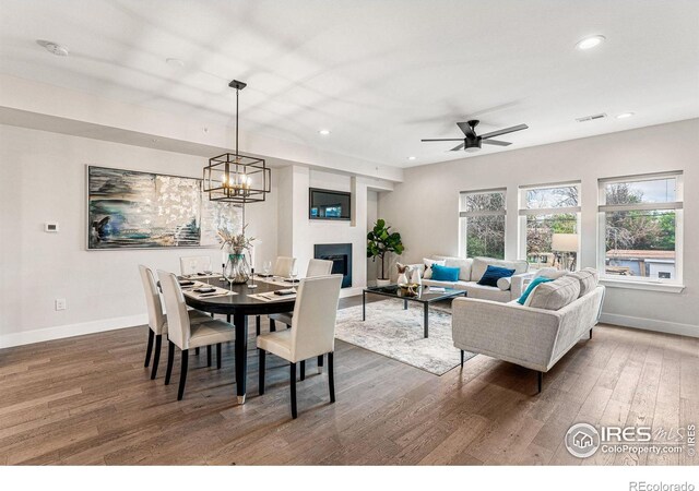 3450 N Downing St Unit 4, Denver, CO 80205 - dining room featuring wood finished floors, recessed lighting, a glass covered fireplace, a ceiling fan, and a chandelier