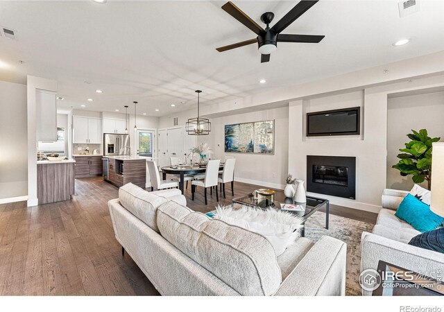 3450 N Downing St Unit 4, Denver, CO 80205 - living room featuring recessed lighting, wood finished floors, ceiling fan, and a glass covered fireplace