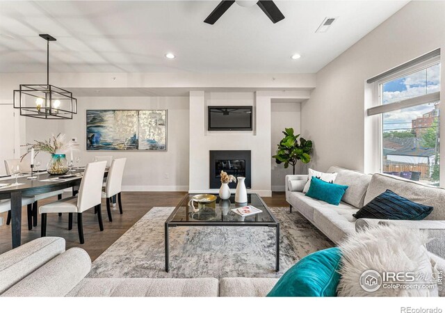 3450 N Downing St Unit 4, Denver, CO 80205 - living area with wood finished floors, a chandelier, a ceiling fan, recessed lighting, and a glass covered fireplace