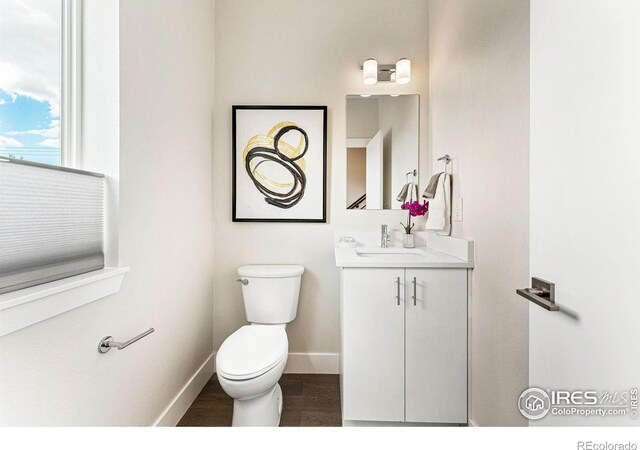 3450 N Downing St Unit 4, Denver, CO 80205 - bathroom featuring vanity and wood finished floors