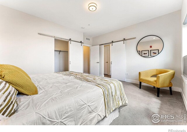 3450 N Downing St Unit 4, Denver, CO 80205 - bedroom with carpet and a barn door