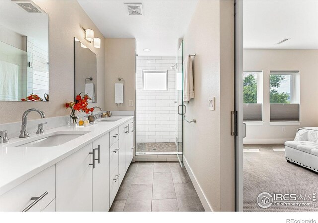 3450 N Downing St Unit 4, Denver, CO 80205 - bathroom with double vanity, a stall shower, and tile patterned flooring