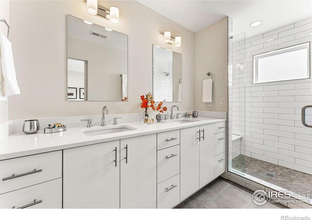 3450 N Downing St Unit 4, Denver, CO 80205 - bathroom featuring double vanity, a shower stall, and tile patterned flooring