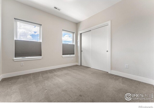 3450 N Downing St Unit 4, Denver, CO 80205 - unfurnished bedroom featuring carpet and a closet