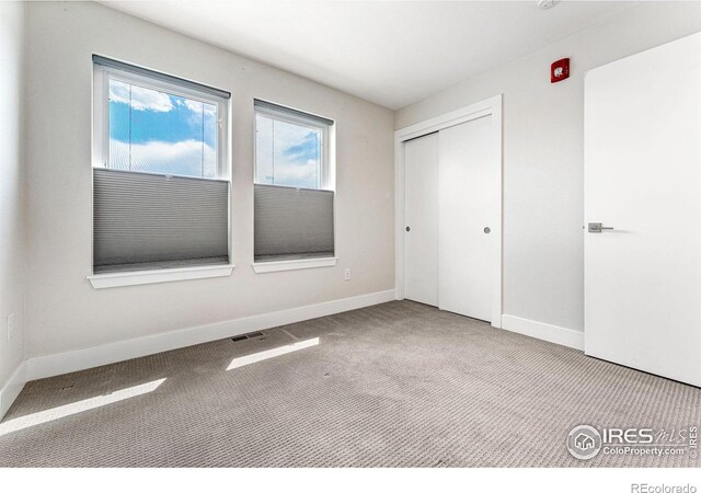 3450 N Downing St Unit 4, Denver, CO 80205 - unfurnished bedroom featuring carpet and a closet