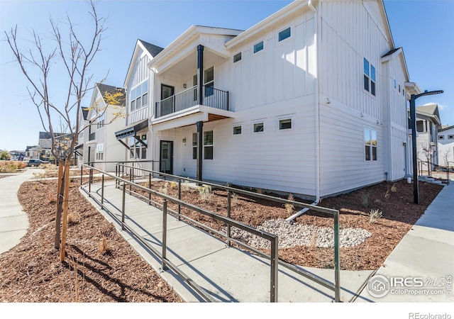 2714 Barnstormer St Unit G, Fort Collins, CO 80524 - view of side of home with board and batten siding, a balcony, and a residential view