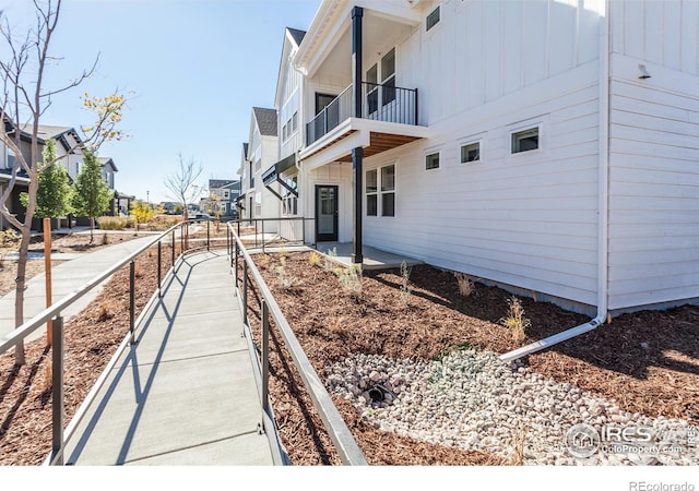 2714 Barnstormer St Unit G, Fort Collins, CO 80524 - view of property exterior featuring a balcony, board and batten siding, and a residential view