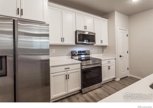 2714 Barnstormer St Unit G, Fort Collins, CO 80524 - kitchen with stainless steel appliances, light countertops, light wood-style flooring, white cabinets, and recessed lighting