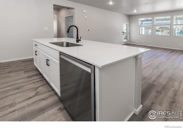 2714 Barnstormer St Unit G, Fort Collins, CO 80524 - kitchen featuring dishwasher, white cabinetry, light wood-style floors, a center island with sink, and open floor plan