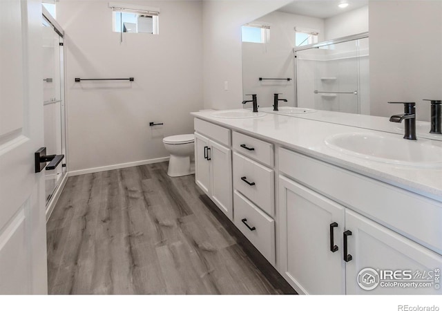 2714 Barnstormer St Unit G, Fort Collins, CO 80524 - full bath featuring a shower stall, double vanity, plenty of natural light, and wood finished floors