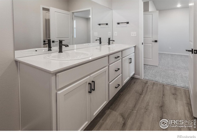 2714 Barnstormer St Unit G, Fort Collins, CO 80524 - bathroom featuring double vanity and wood finished floors