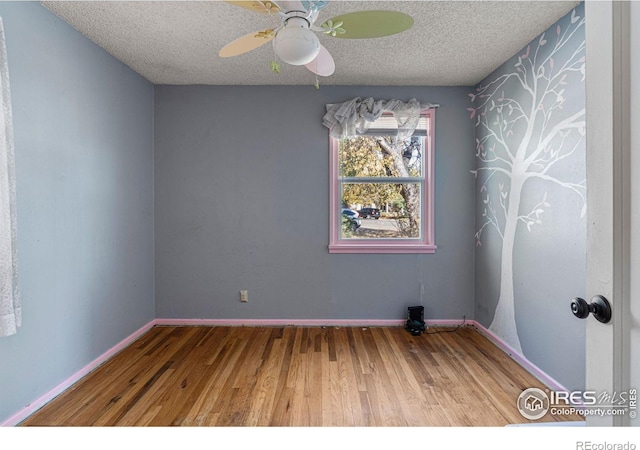 1109 Ironton St, Aurora, CO 80010 - spare room with wood finished floors, a textured ceiling, and ceiling fan
