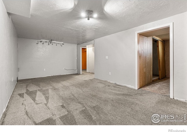 1109 Ironton St, Aurora, CO 80010 - unfurnished room featuring carpet, track lighting, and a textured ceiling