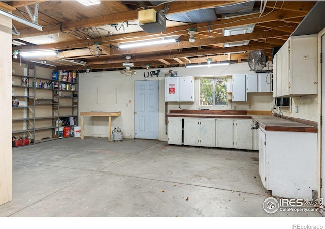 1109 Ironton St, Aurora, CO 80010 - garage with a workshop area and a garage door opener