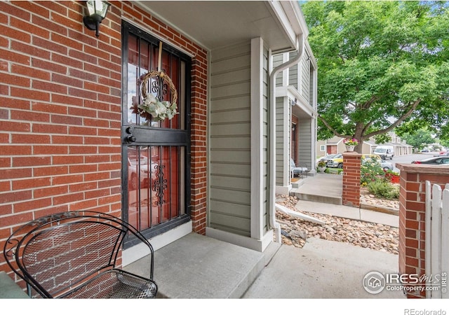 7474 E Arkansas Ave Unit 12, Denver, CO 80231 - doorway to property with brick siding and covered porch
