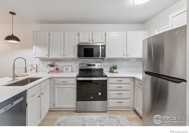 7474 E Arkansas Ave Unit 12, Denver, CO 80231 - kitchen featuring appliances with stainless steel finishes, light wood finished floors, tasteful backsplash, and light countertops