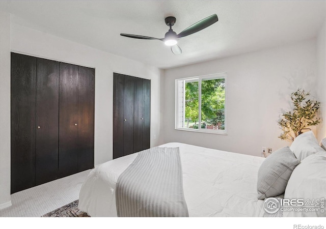 7474 E Arkansas Ave Unit 12, Denver, CO 80231 - carpeted bedroom featuring multiple closets and a ceiling fan