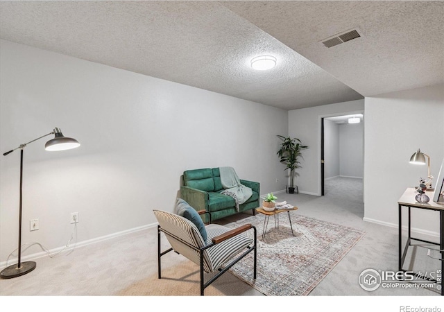 7474 E Arkansas Ave Unit 12, Denver, CO 80231 - living area featuring carpet flooring and a textured ceiling