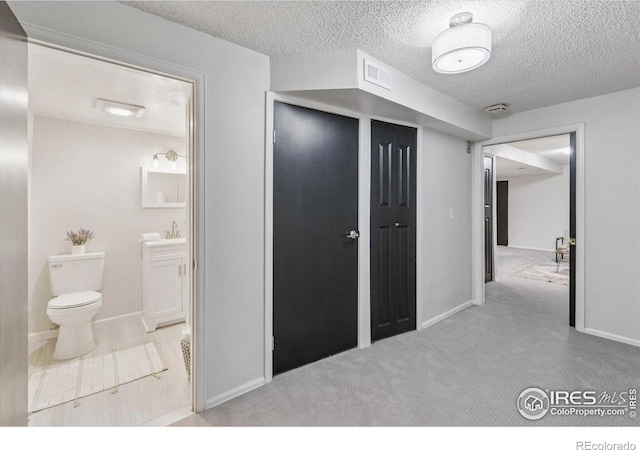 7474 E Arkansas Ave Unit 12, Denver, CO 80231 - hall featuring a textured ceiling