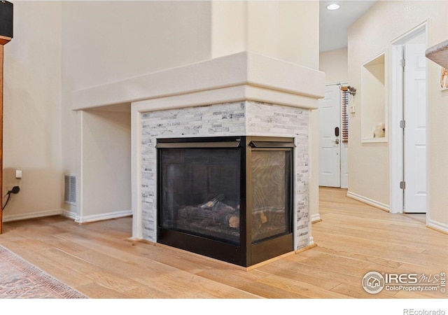 3000 E 112th Ave Unit 102, Northglenn, CO 80233 - detailed view of a fireplace, wood finished floors, and recessed lighting