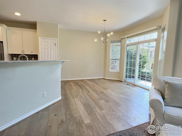 3000 E 112th Ave Unit 102, Northglenn, CO 80233 - dining area featuring a chandelier, light wood-style flooring, and recessed lighting