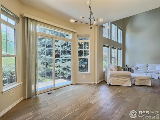 3000 E 112th Ave Unit 102, Northglenn, CO 80233 - doorway to outside featuring wood-type flooring and a chandelier