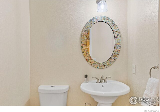 3000 E 112th Ave Unit 102, Northglenn, CO 80233 - half bathroom with toilet and a sink